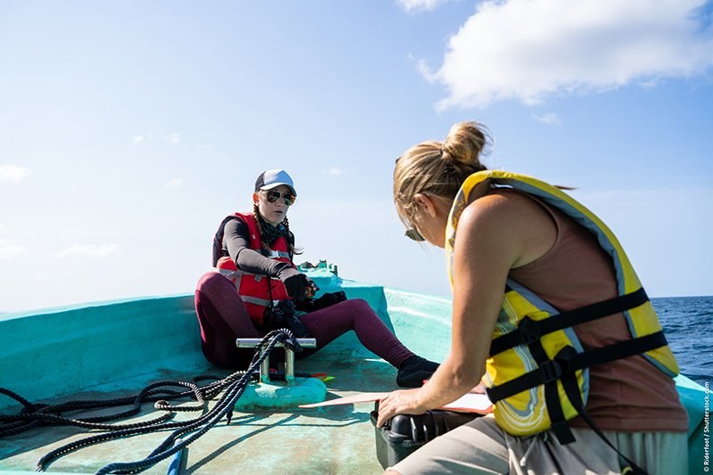 Researchers operating equipment on a boat
